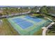 Two tennis courts with green and blue surface, surrounded by fence at 820 Spring Oak Cir, Orlando, FL 32828