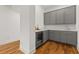 Gray cabinetry with quartz countertop and wine cooler in basement bar area at 8361 Ludington Cir, Orlando, FL 32836