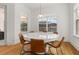 Round white table with six brown leather chairs in breakfast nook at 8361 Ludington Cir, Orlando, FL 32836