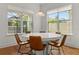 Round white table with six brown leather chairs in breakfast nook at 8361 Ludington Cir, Orlando, FL 32836