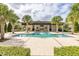 Community pool with covered patio and grilling area at 8361 Ludington Cir, Orlando, FL 32836