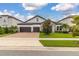 House exterior featuring a two-car garage and manicured lawn at 8361 Ludington Cir, Orlando, FL 32836