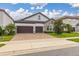 Two-story house with a large driveway and a neat lawn at 8361 Ludington Cir, Orlando, FL 32836