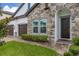 Front entry featuring a stone facade and landscaping at 8361 Ludington Cir, Orlando, FL 32836