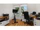 Spacious home office with hardwood floors, desk, and exercise bike at 8361 Ludington Cir, Orlando, FL 32836