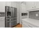 Stainless steel refrigerator and white shaker cabinets in kitchen at 8361 Ludington Cir, Orlando, FL 32836