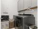 Modern laundry room featuring washer, dryer, and ample cabinetry at 8361 Ludington Cir, Orlando, FL 32836