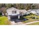 A beautiful two-story white home with a grey garage door, on a sunny day at 862 Shriver Cir, Lake Mary, FL 32746