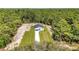 Breathtaking aerial view of a modern home nestled in a serene, wooded landscape at 9095 Sw 125Th Ter, Dunnellon, FL 34432