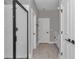 Bright bathroom with double doors, white cabinets, wood flooring, and a glass shower at 9095 Sw 125Th Ter, Dunnellon, FL 34432