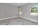 Bedroom featuring neutral paint colors, updated flooring, and windows providing exterior views at 9095 Sw 125Th Ter, Dunnellon, FL 34432