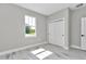 Bright bedroom featuring a large window and closet with sliding doors at 9095 Sw 125Th Ter, Dunnellon, FL 34432