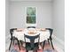 Bright dining room with round table and six black chairs at 9095 Sw 125Th Ter, Dunnellon, FL 34432