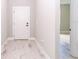 White door entry to a hallway with light wood-look tile floor at 9095 Sw 125Th Ter, Dunnellon, FL 34432