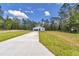 Newly constructed home featuring a long driveway and a simple yet elegant modern design at 9095 Sw 125Th Ter, Dunnellon, FL 34432