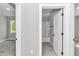 Hallway view showcasing doors to the bathroom and bedroom with stylish flooring at 9095 Sw 125Th Ter, Dunnellon, FL 34432