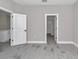 Hallway featuring doors, neutral paint colors, and updated flooring at 9095 Sw 125Th Ter, Dunnellon, FL 34432