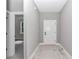 Bright hallway with wood-look tile flooring and neutral paint, offering access to other rooms at 9095 Sw 125Th Ter, Dunnellon, FL 34432