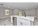 The kitchen island with hard surface floors separates the living space at 9095 Sw 125Th Ter, Dunnellon, FL 34432