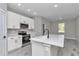 Bright kitchen featuring stainless appliances, an island, and white cabinetry at 9095 Sw 125Th Ter, Dunnellon, FL 34432