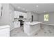 Modern kitchen boasts stainless appliances, island with sink and hard surface floors at 9095 Sw 125Th Ter, Dunnellon, FL 34432