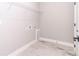 Laundry room with white walls, wire shelving, and wood-look tile floor at 9095 Sw 125Th Ter, Dunnellon, FL 34432