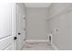 A convenient laundry room includes storage shelves and utility hookups at 9095 Sw 125Th Ter, Dunnellon, FL 34432