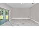 Bright living room with sliding glass doors and contemporary neutral paint colors at 9095 Sw 125Th Ter, Dunnellon, FL 34432