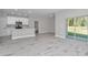 Open-concept living space featuring contemporary paint colors, kitchen, and sliding glass doors at 9095 Sw 125Th Ter, Dunnellon, FL 34432