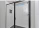 Modern shower features sleek glass enclosure, subway tile, window, and dark hardware at 9095 Sw 125Th Ter, Dunnellon, FL 34432