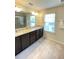 Double vanity bathroom with granite countertop and large mirror at 1100 Pavia Dr, Apopka, FL 32703