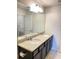Double vanity bathroom with granite countertops and big mirror at 1100 Pavia Dr, Apopka, FL 32703