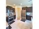 Modern kitchen with stainless steel appliances and dark wood cabinets at 1100 Pavia Dr, Apopka, FL 32703