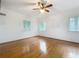 Well-lit bedroom showcasing hardwood floors and ceiling fan at 1138 Overbrook Dr, Orlando, FL 32804