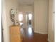 Light-filled hallway with dresser and wood flooring at 1161 Charming St, Maitland, FL 32751