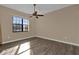 Well-lit bedroom featuring a large window and ceiling fan at 140 Stratford Ct, Haines City, FL 33844