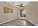 Bedroom with wood-look floors, ceiling fan, and large window at 140 Stratford Ct, Haines City, FL 33844