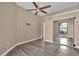 Bright bedroom with laminate wood floor, ceiling fan, and mirrored closet doors at 140 Stratford Ct, Haines City, FL 33844