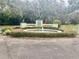 Circular drive entrance to a community with a central fountain at 140 Stratford Ct, Haines City, FL 33844