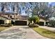 Front view of a two-story building with brown garage doors and palm trees at 140 Stratford Ct, Haines City, FL 33844