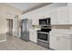 Kitchen features stainless steel appliances and white cabinetry at 140 Stratford Ct, Haines City, FL 33844