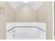 White bathtub with tile surround, ideal for relaxation at 1407 Chatfield Pl, Orlando, FL 32814
