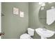 Small bathroom with white sink, toilet, and oval mirror at 1407 Chatfield Pl, Orlando, FL 32814