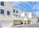 Row of townhomes with attached garages and manicured lawns at 1407 Chatfield Pl, Orlando, FL 32814