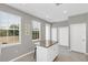 White kitchen with granite island and access to outdoor balcony at 1407 Chatfield Pl, Orlando, FL 32814