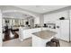 Modern kitchen with white cabinets, granite island, and view of living area at 1407 Chatfield Pl, Orlando, FL 32814