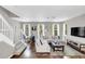 Open living space with hardwood floors, sectional sofa, and staircase at 1407 Chatfield Pl, Orlando, FL 32814
