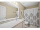 Bathroom with single vanity, shower/tub combo and white vanity at 14236 Golden Rain Tree Blvd, Orlando, FL 32828