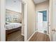 Hallway view of bedroom and bathroom with wood-look tile flooring at 14236 Golden Rain Tree Blvd, Orlando, FL 32828