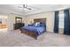 Main bedroom with a dark wood bed frame and plenty of natural light at 14236 Golden Rain Tree Blvd, Orlando, FL 32828